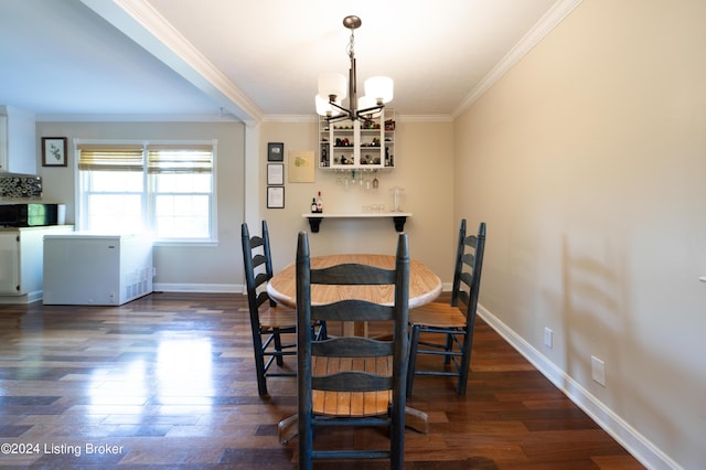 dining room featuring dark wood-type flooring, an inviting chandelier, and ornamental molding