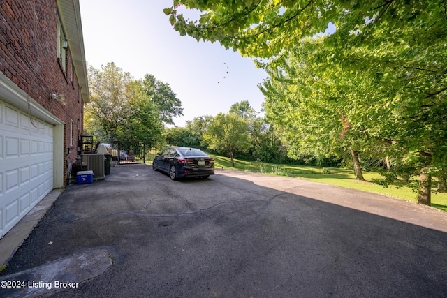 view of vehicle parking with a garage