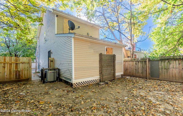 rear view of house featuring central air condition unit