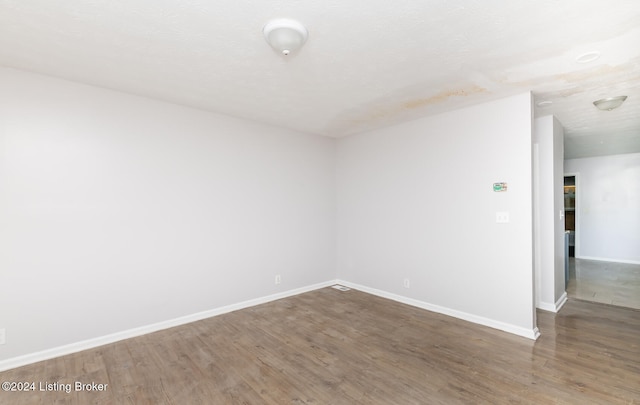 spare room with dark hardwood / wood-style flooring