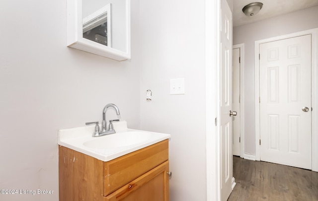 bathroom featuring vanity and hardwood / wood-style floors