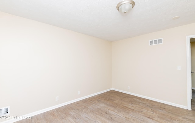 empty room with light hardwood / wood-style flooring