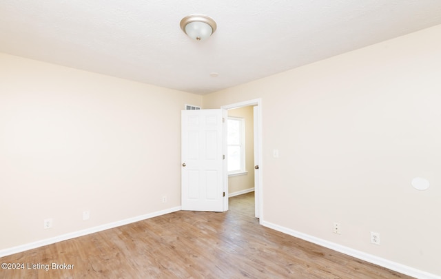 unfurnished room with light hardwood / wood-style floors