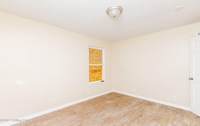 empty room with light hardwood / wood-style flooring