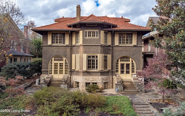 rear view of property with french doors