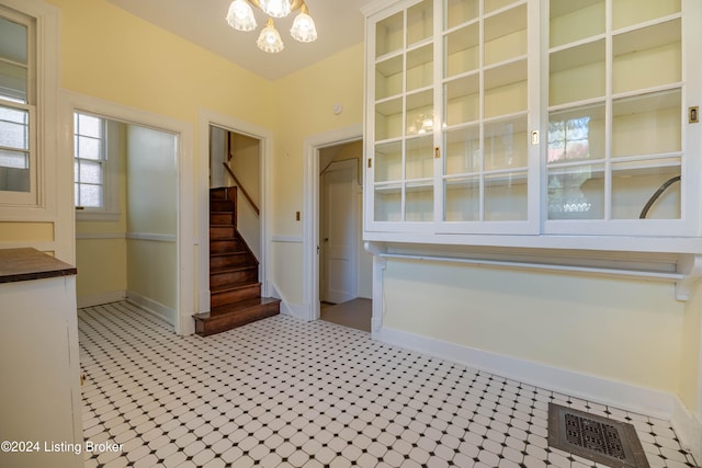 stairs featuring an inviting chandelier