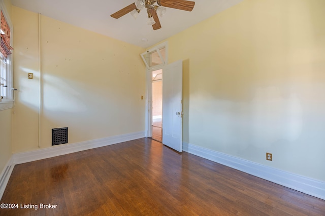 spare room with ceiling fan, dark wood-type flooring, and a wealth of natural light