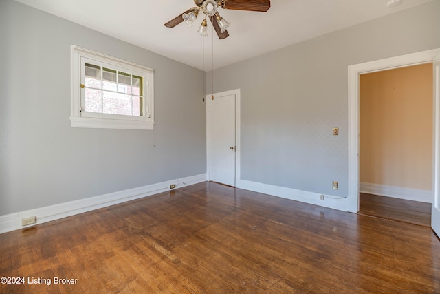 empty room featuring dark hardwood / wood-style flooring and ceiling fan