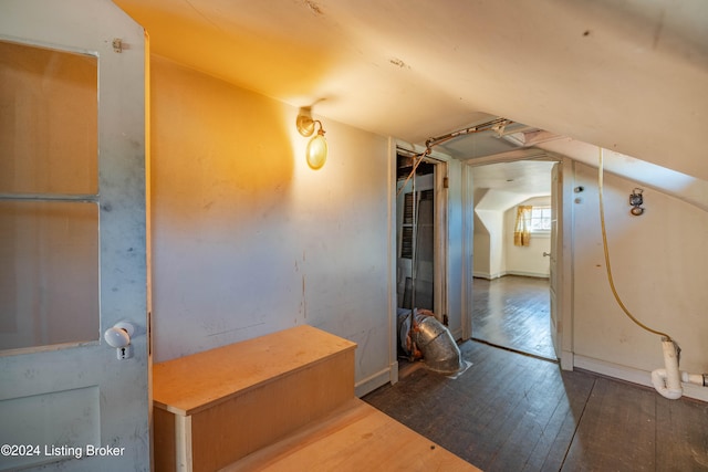 interior space with dark hardwood / wood-style flooring and lofted ceiling