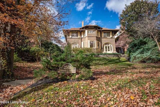 rear view of property with a yard