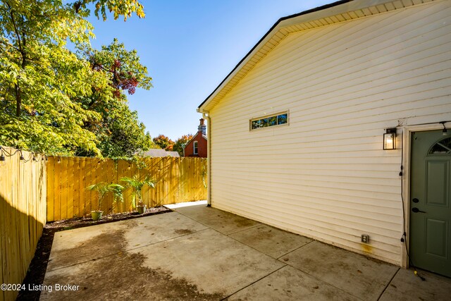 view of side of property with a patio area