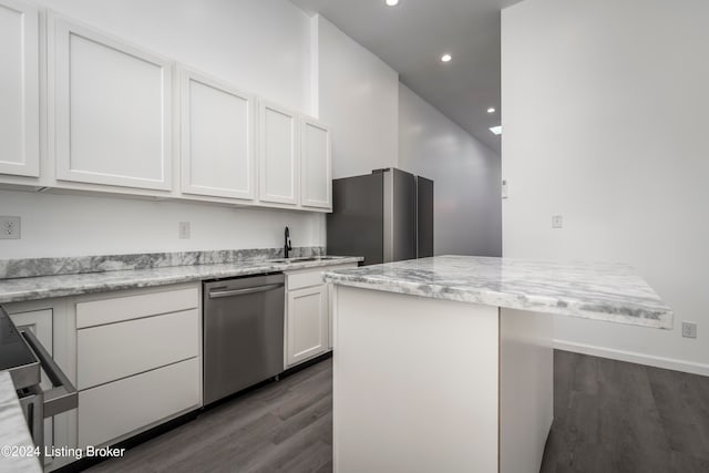 kitchen featuring sink, dark hardwood / wood-style floors, light stone countertops, white cabinetry, and appliances with stainless steel finishes