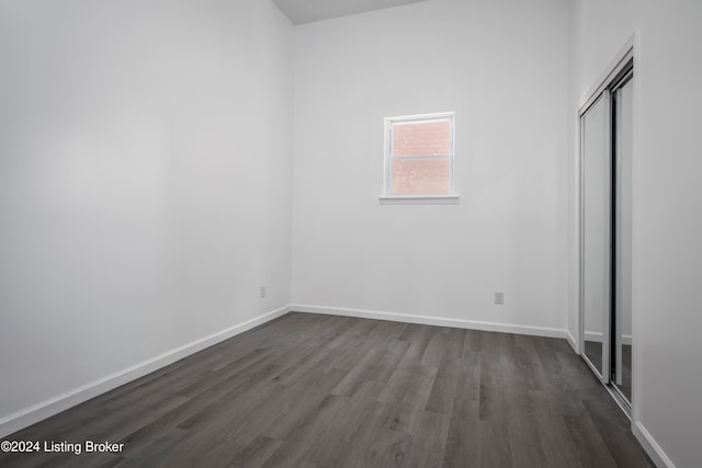 unfurnished bedroom featuring dark wood-type flooring