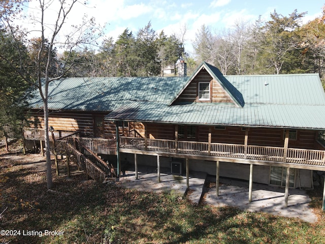 rear view of property featuring a patio area and a deck