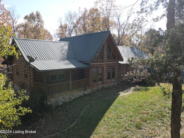 rear view of property featuring a lawn