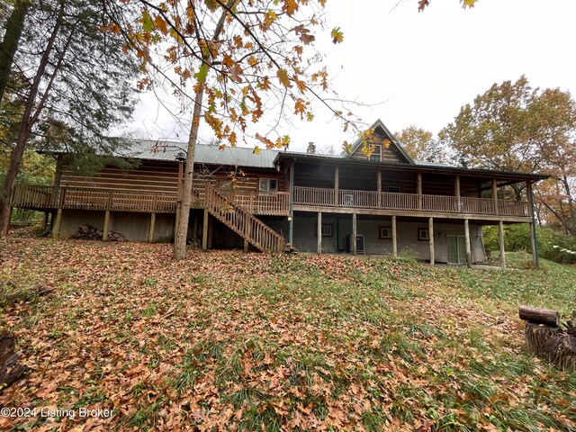 back of property with a wooden deck