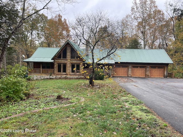 log-style house with a garage, a front yard, and covered porch