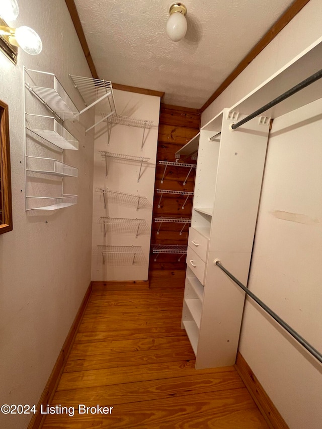 spacious closet featuring hardwood / wood-style flooring