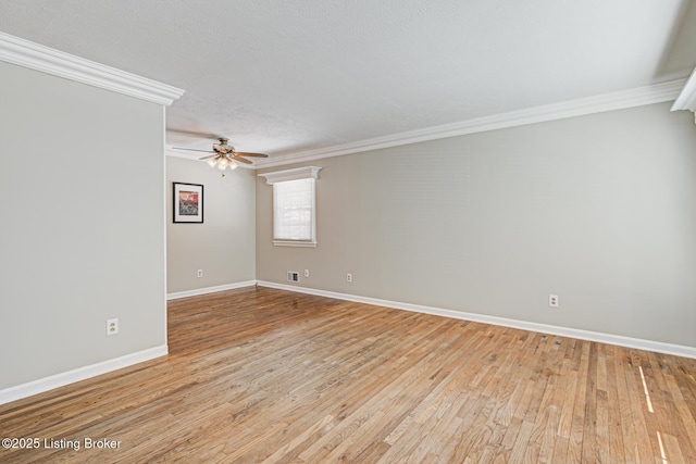 empty room featuring light wood-style floors and crown molding