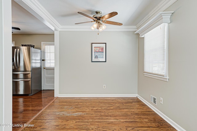 interior space featuring ornamental molding, ceiling fan, baseboards, and wood finished floors