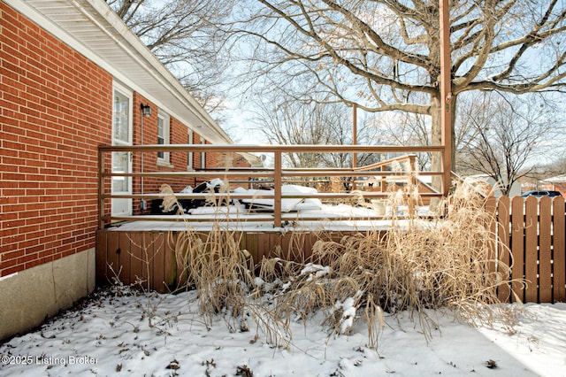 snow covered deck with fence