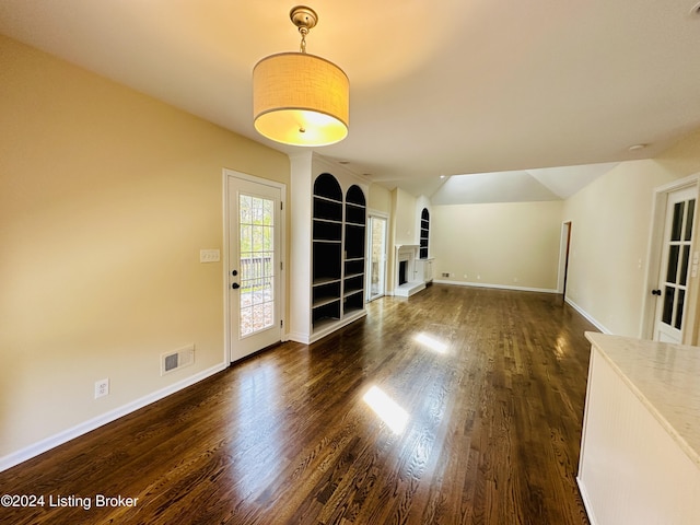 unfurnished living room with dark hardwood / wood-style floors and vaulted ceiling