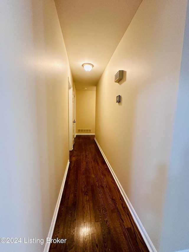 corridor featuring dark hardwood / wood-style floors