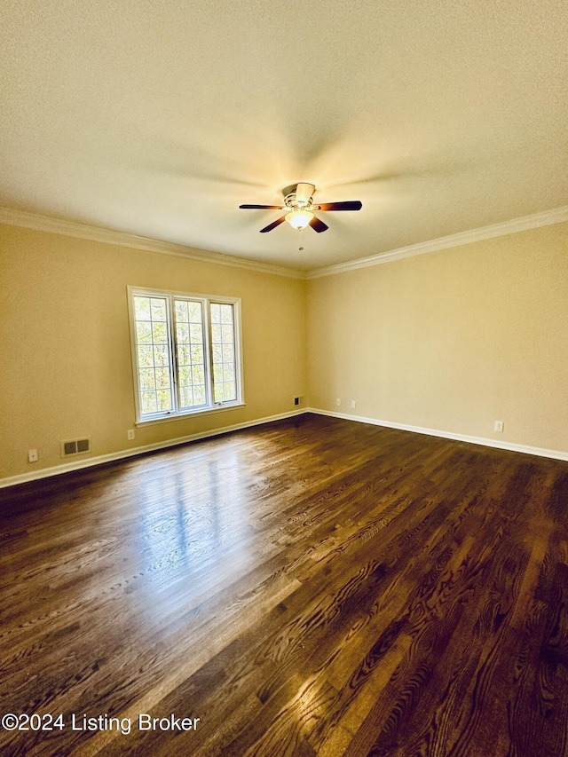 spare room featuring ceiling fan, dark hardwood / wood-style flooring, ornamental molding, and a textured ceiling