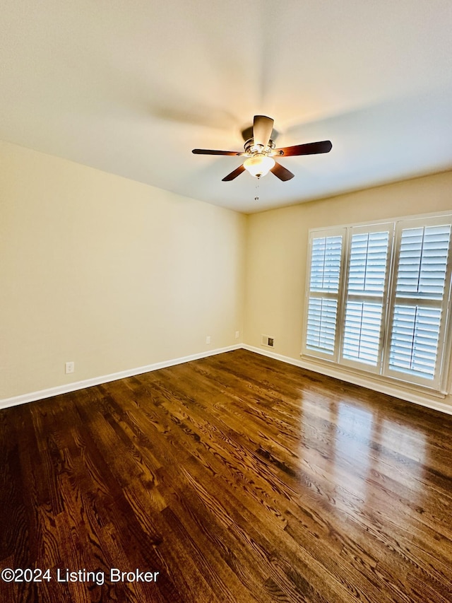 unfurnished room featuring dark hardwood / wood-style floors and ceiling fan