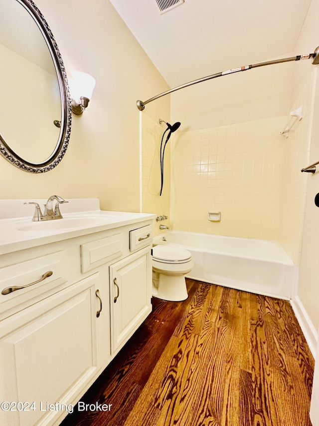 full bathroom with vanity,  shower combination, wood-type flooring, toilet, and lofted ceiling