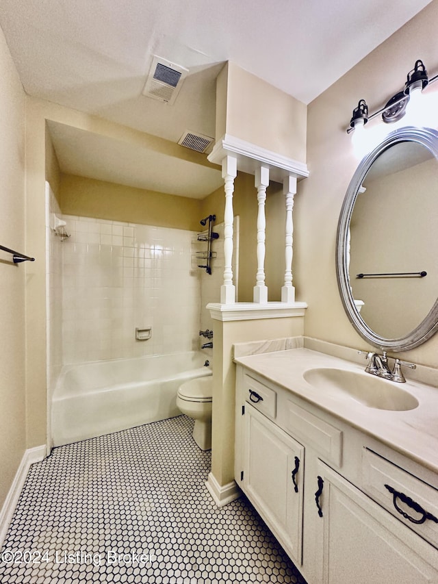 full bathroom featuring vanity, toilet, and tiled shower / bath