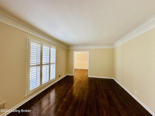 unfurnished room with ornamental molding and dark wood-type flooring