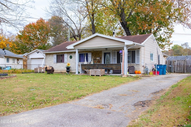 view of front facade with a porch, a garage, a front lawn, and central air condition unit