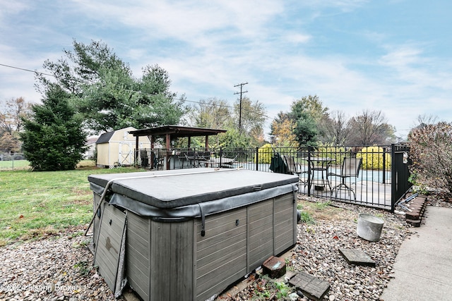 view of yard with a storage unit and a hot tub