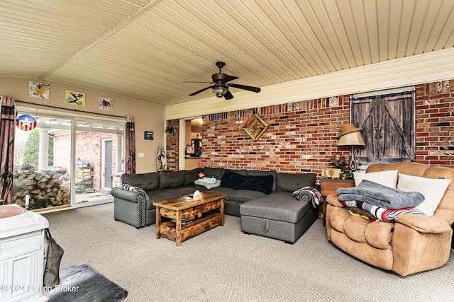 living room featuring ceiling fan, brick wall, lofted ceiling, and carpet floors