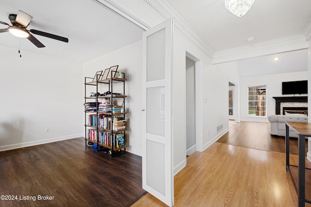 hallway featuring hardwood / wood-style floors and crown molding