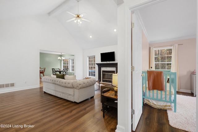 living room with dark wood-type flooring, high vaulted ceiling, ornamental molding, and ceiling fan with notable chandelier