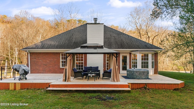 rear view of property with a deck, a lawn, a gazebo, and an outdoor living space