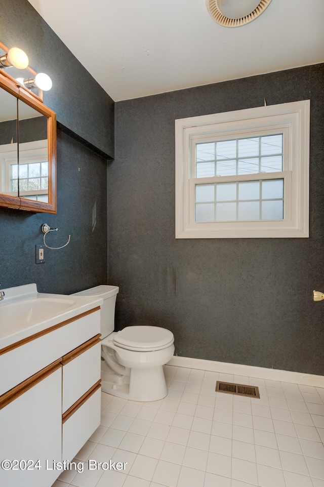 bathroom featuring vanity, tile patterned floors, and toilet