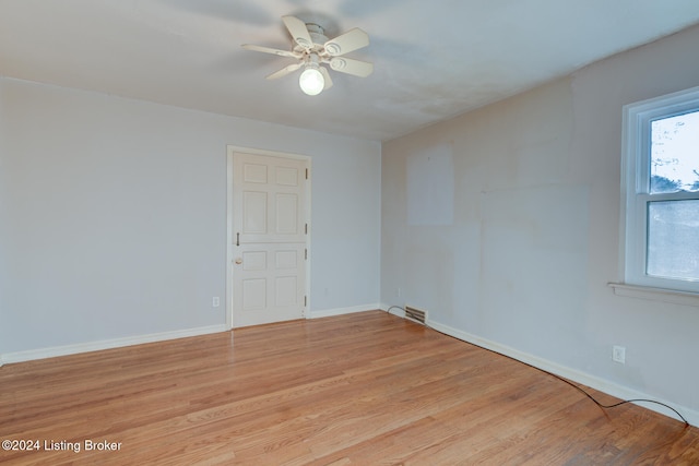 spare room with light hardwood / wood-style floors and ceiling fan