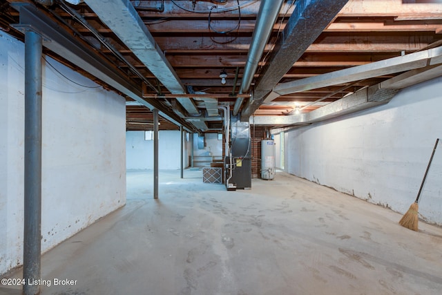 basement featuring gas water heater and heating unit