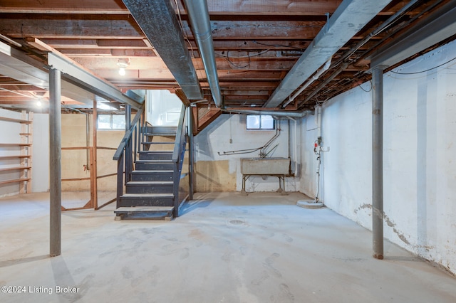 basement featuring a wealth of natural light and sink