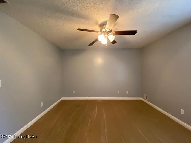 unfurnished room featuring a textured ceiling, hardwood / wood-style floors, and ceiling fan