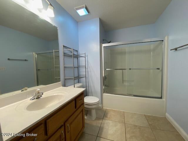 full bathroom with toilet, vanity, tile patterned flooring, and shower / bath combination with glass door