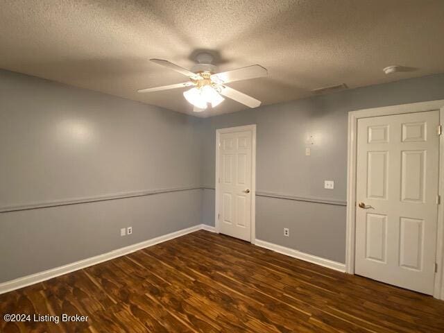 spare room with ceiling fan, dark hardwood / wood-style floors, and a textured ceiling