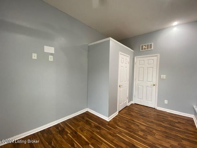 empty room with dark hardwood / wood-style floors