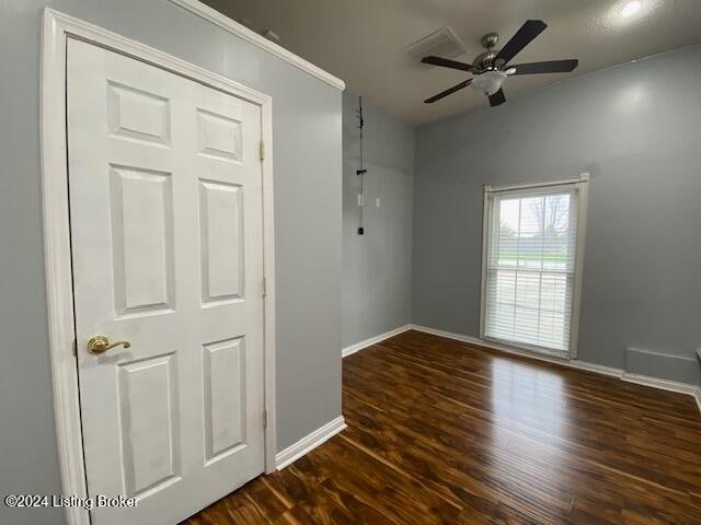 unfurnished room with dark hardwood / wood-style flooring and ceiling fan