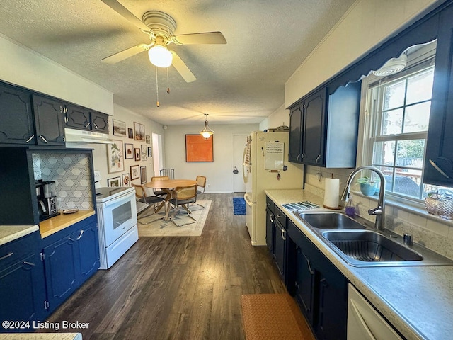 kitchen featuring hanging light fixtures, sink, decorative backsplash, dark wood-type flooring, and white appliances