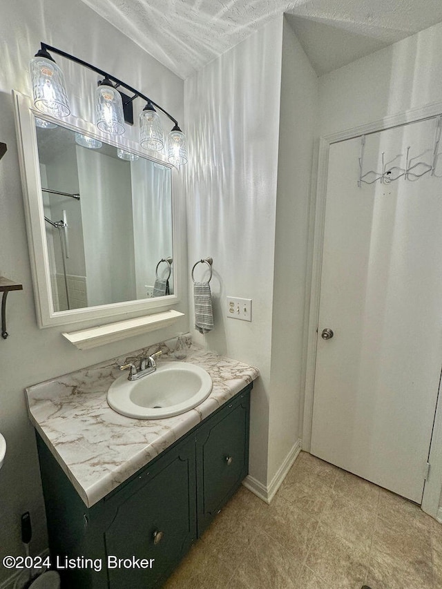 bathroom with vanity and a textured ceiling