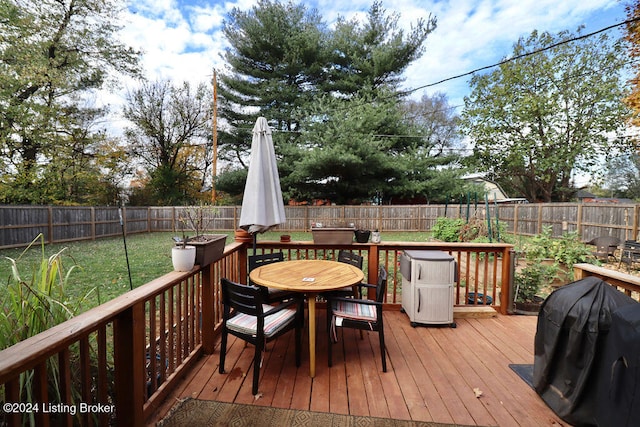 deck with a lawn and a grill